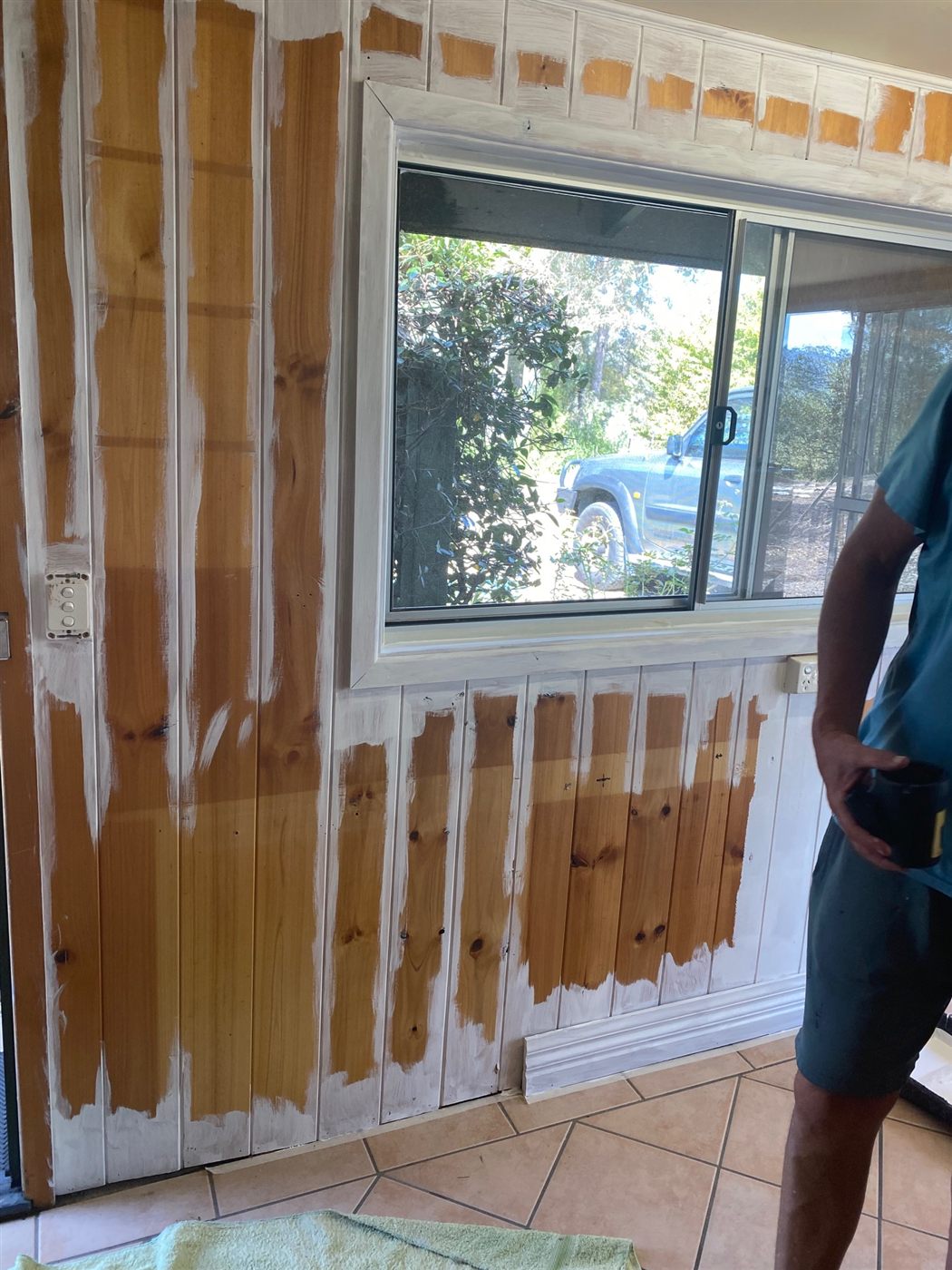 Knotty pine bedroom walls mid-painting
