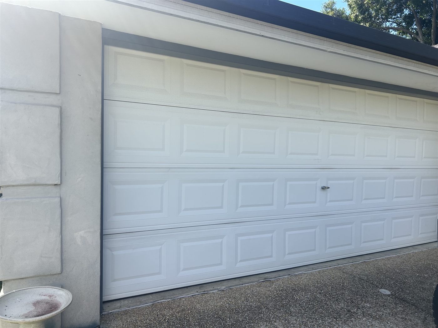 Tired white garage door before repainting